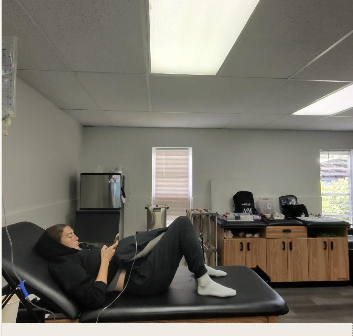 Founding athlete receiving IV hydration therapy at a Dripping Wellness recovery session
